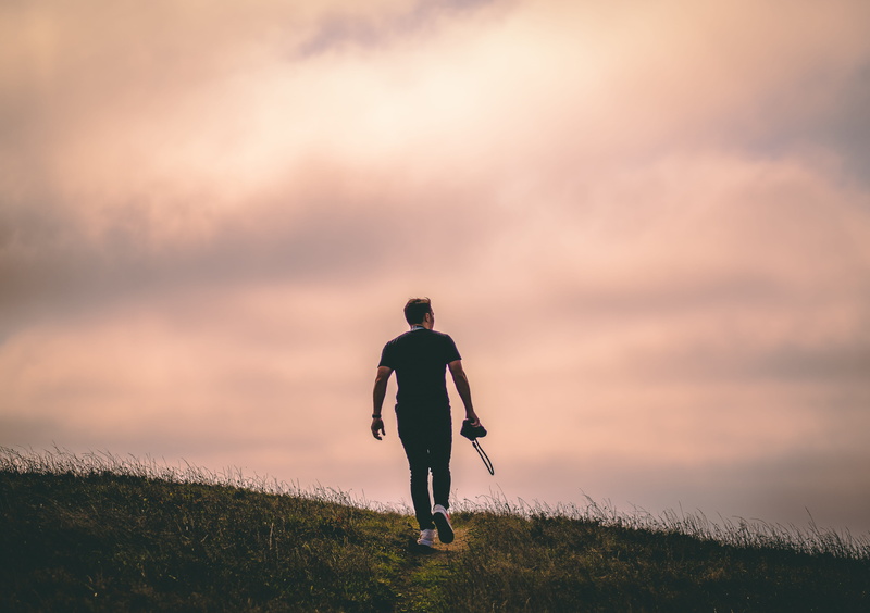 beauty in nature, walking, sunlight, point reyes national seashore, man, outdoors, cloud - sky, united states, leisure activities, grass, dirt road, person