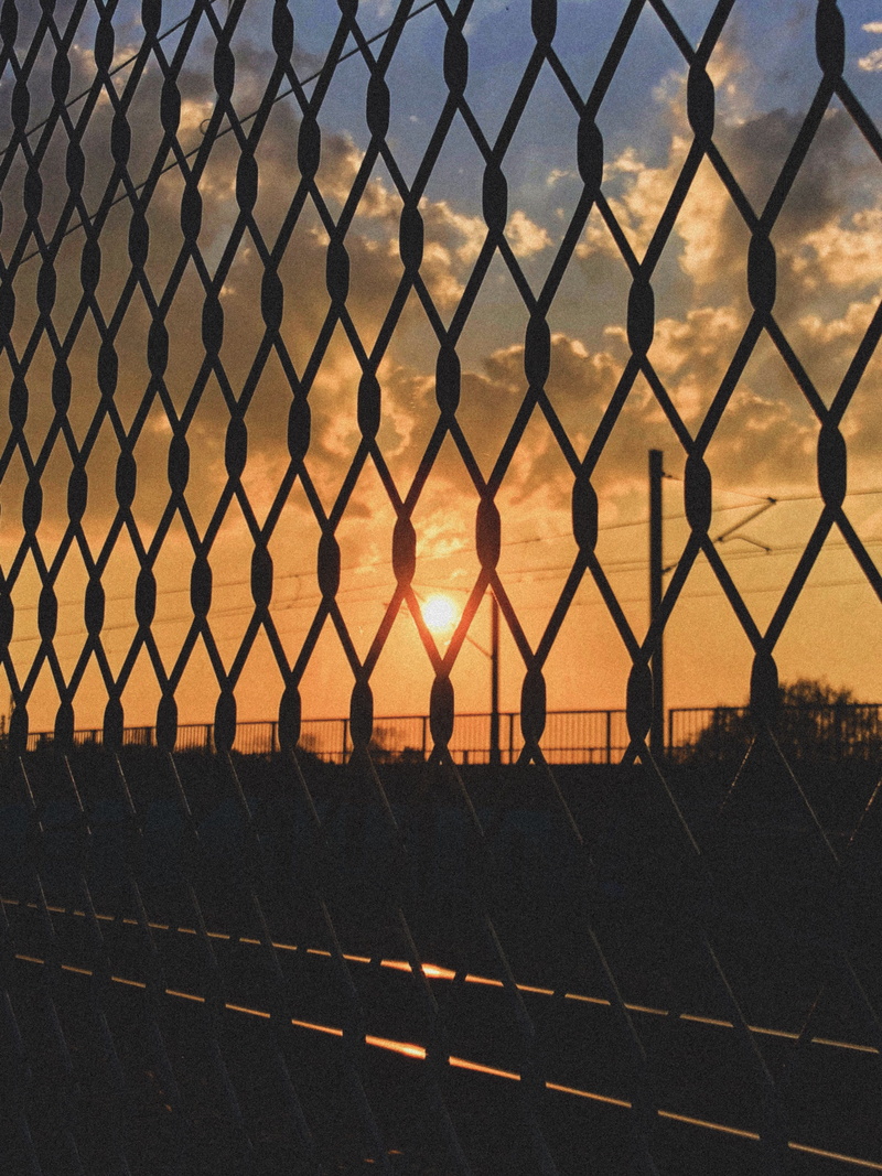 real people, road, linked fence, grainy, sun, sky, protection, transportation, tracks, chainlink fence, 4K, clouds, barrier, metal, wires, nature, safety