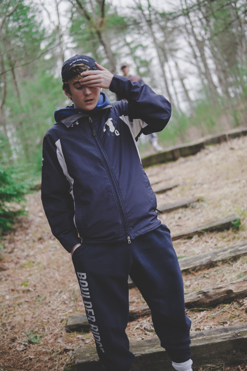 three quarter length, one person, forest, denim, outdoors, plant, sleeve, standing, apparel, clothing, overcoat, pants, transportation, tree, young men