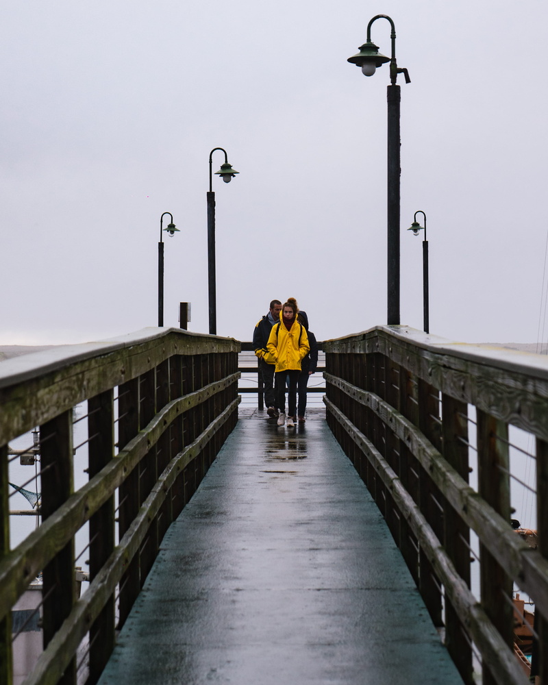 real people, raincoat, color, built structure, person, contrast, street, outdoors, moody, street light, architecture, the way forward, fog, apparel, men