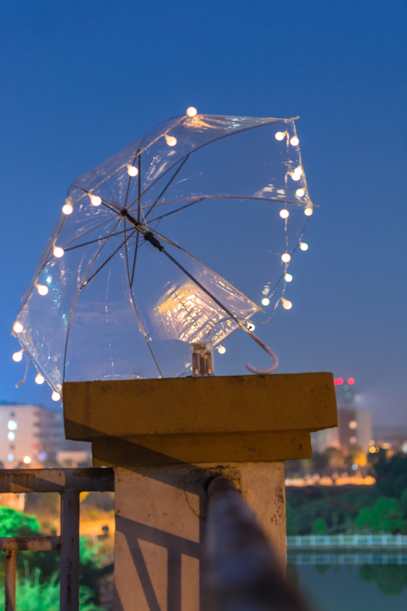 electricity, christmas lights, dusk, illuminated, no people, architecture, clear sky, low angle view, umbrella, light, lighting equipment, blue, focus on foreground