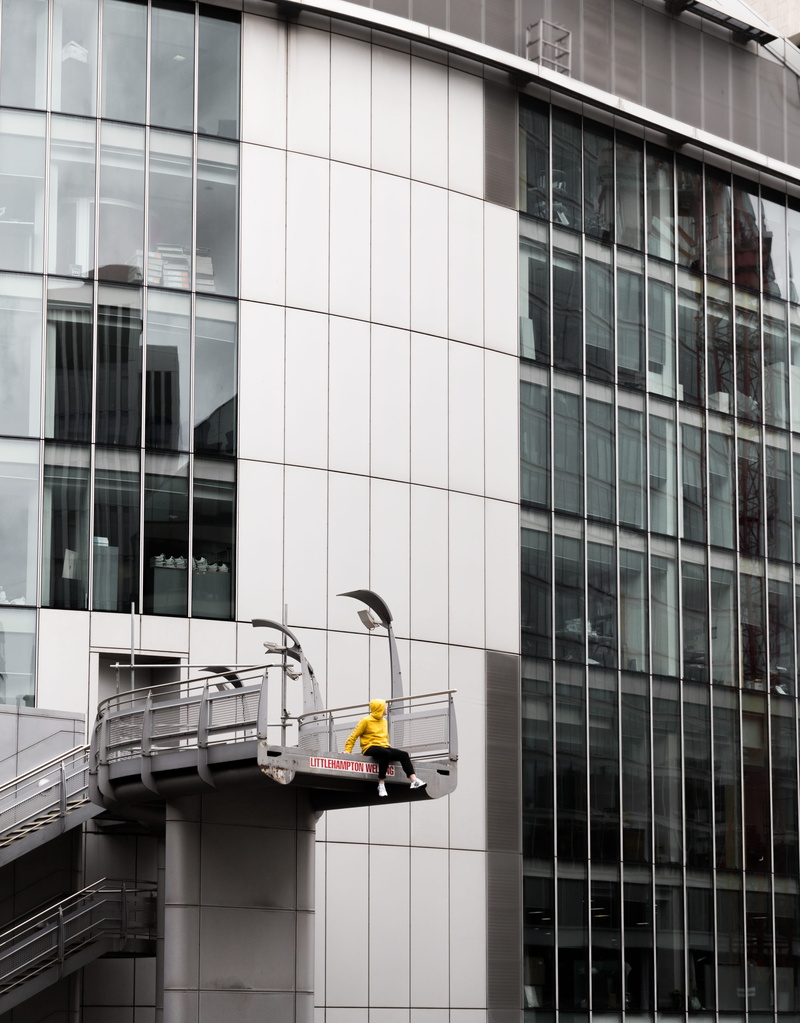 male, office building exterior, built structure, sitting, modern, structure, day, hoodie, man, yellow, glass - material, street, working, 4K, daytime