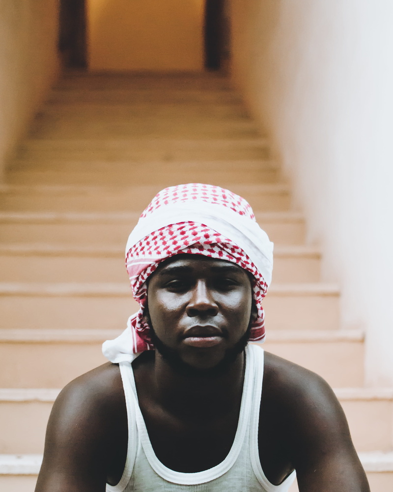 focus on foreground, built structure, healthy lifestyle, white, front view, steps and staircases, keffiyeh, photo, sitting, 2K, top, day, stairs, headshot