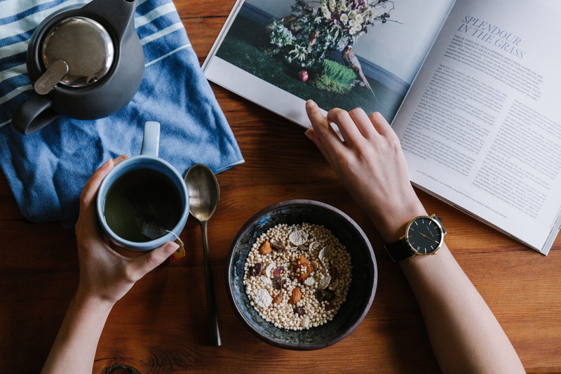 fashion, person, read, coffee - drink, healthy, drink, spoon, coffee cup, muesli, magazine, wristwatch, cup, hand, hot drink, high angle view, breakfast
