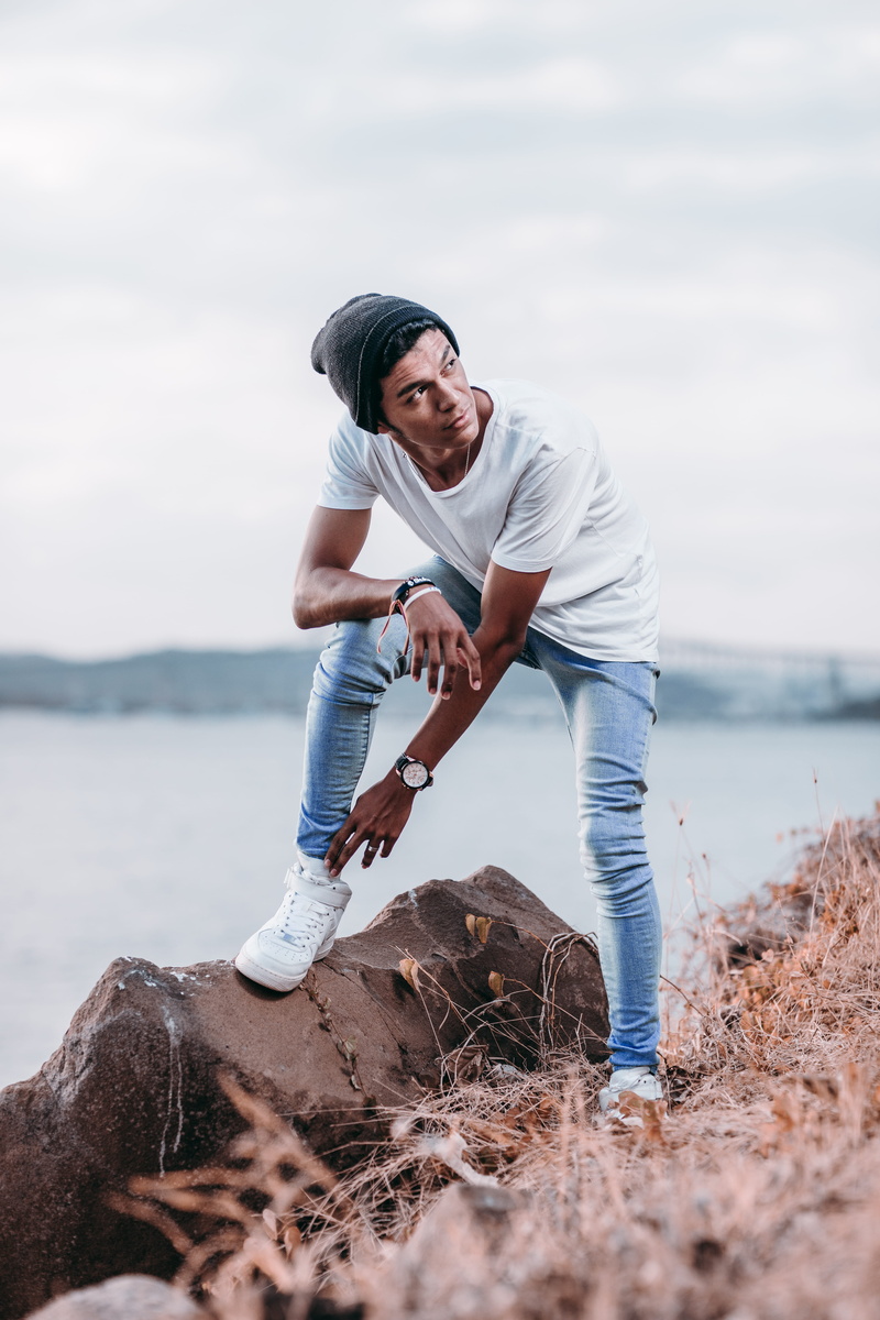 lifestyles, cap, real people, footwear, hat, apparel, sky, full length, pants, nature, leisure activities, smiling, young men, looking, leisure activity