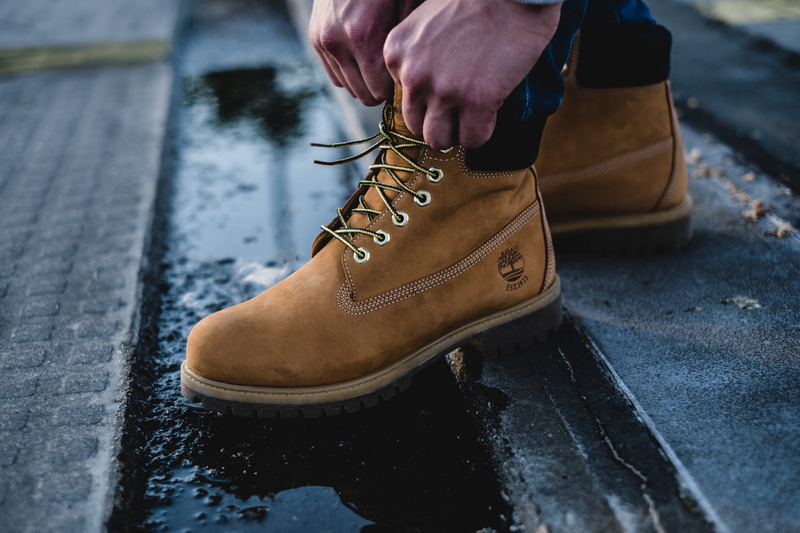 body part, shoelace, human body part, city, day, human, men, human leg, holding, architecture, steeple, standing, cowboy boot, human foot, leather, brown