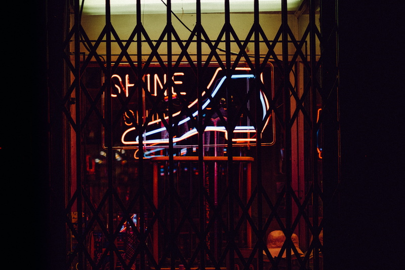 lowlight, black, shoe, red, neon, stage, 5K, street, men, pattern, seat, metal, people, fashion, fance, shine, real people, nighttime, arts culture and entertainment