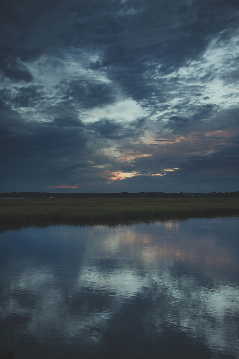 sound, beauty in nature, lifestyle, sunset, stone harbor, sky, lake, evening, tranquil scene, water, dusk, grass, outdoors, tranquility, idyllic, sun, cloud - sky
