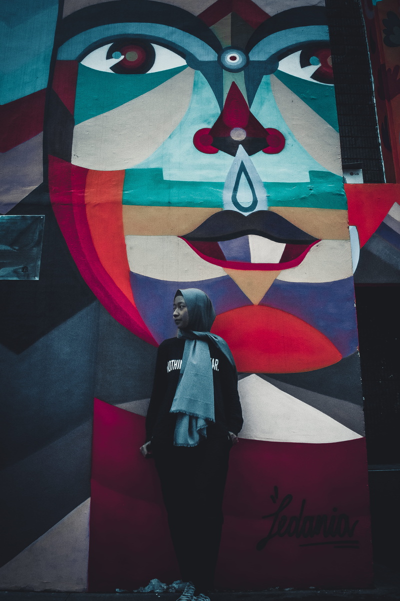 standing, creativity, indoors, abaya, dress, communication, casual clothing, representation, flag, day, one person, young adult, near, front view, leisure activity