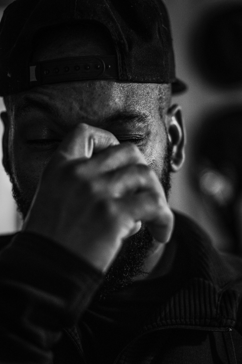 grayscale, hood, hat, focus on foreground, adult, close-up, snapback, lifestyles, communication, front view, leisure activity, portrait, mid adult men