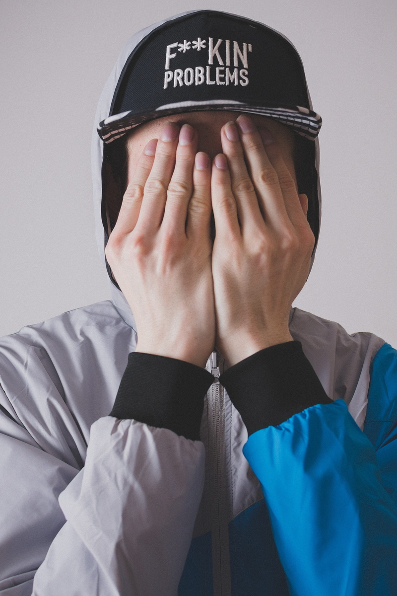 menswear, males, human body part, male, hide the face, portrait, gray, snapback, one person, western script, close-up, adult, the hands on the face, text