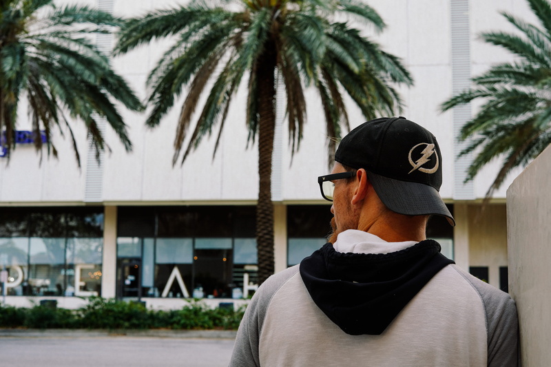 apparel, tampa, usa, person, standing, casual clothing, men, headshot, building exterior, tropical climate, black, cap, plant, face, leisure activity, man
