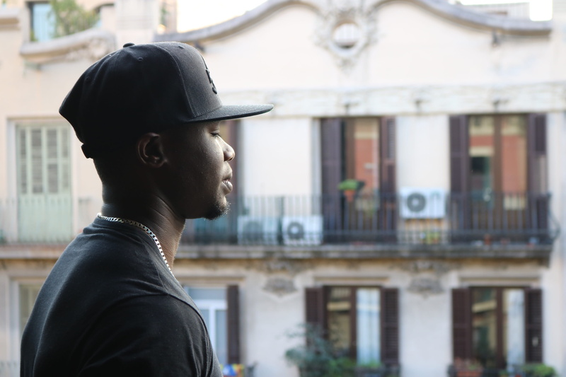 black model, vacation, focus on foreground, young man, looking sideways, tourist, built structure, looking down, representation, only men, lifestyles, side view