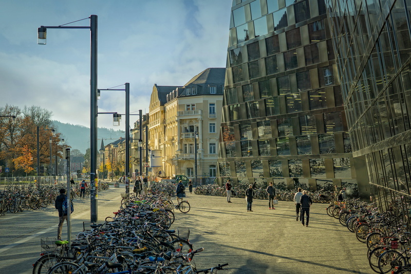men, road, day, windows, street, adult, built structure, building exterior, light, transportation system, group of people, real people, landscape, urban