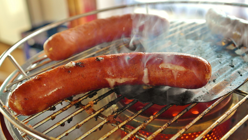 focus on foreground, preparing food, fire - Natural Phenomenon, food and drink, wellbeing, barbecue Grill, pork, metal, heat - Temperature, sausage, indoors