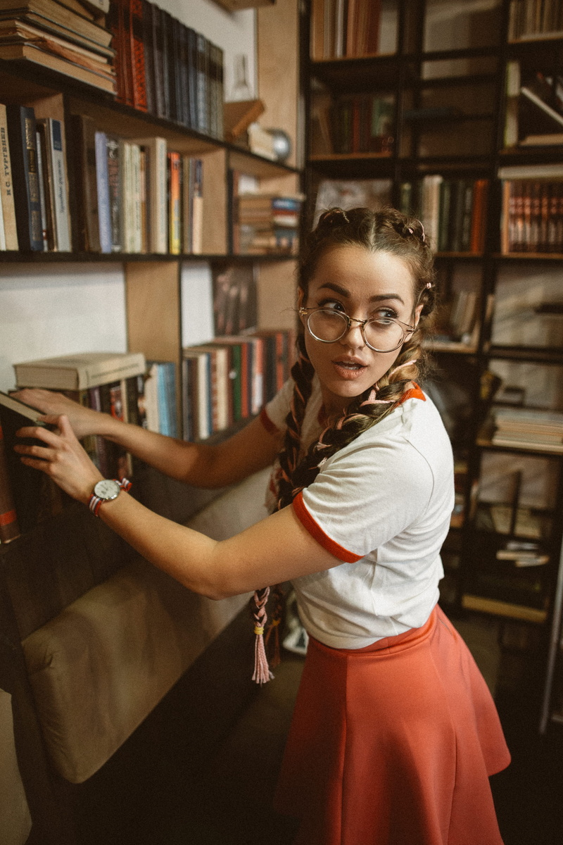 three quarter length, glasses, braid, fashion, 5K, girl, standing, books, book, away, woman, lifestyles, smiling, publication, women, putting, beautiful woman