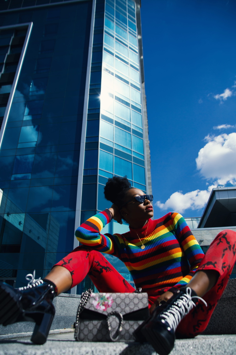 leisure activity, girl, low angle view, sunglasses, lifestyles, fashion, person, turtle, day, colorful, front view, neck, shirt, urban, pants, three quarter length
