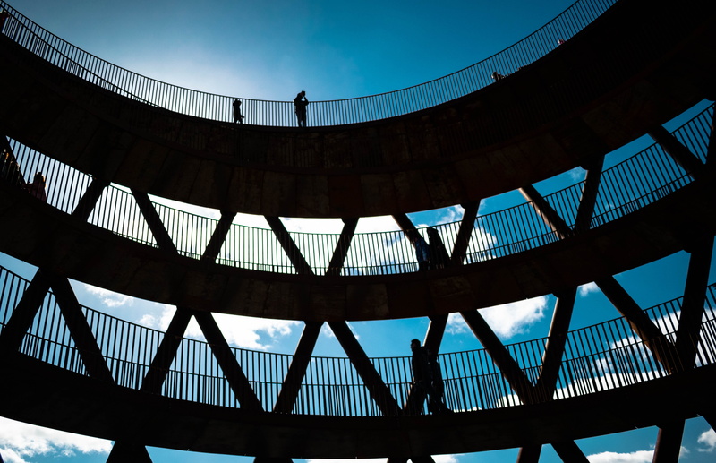 outdoors, silhouette, blue, building, nature, blocking sun, high contrast, travel destinations, person, white clouds, building exterior, window, human