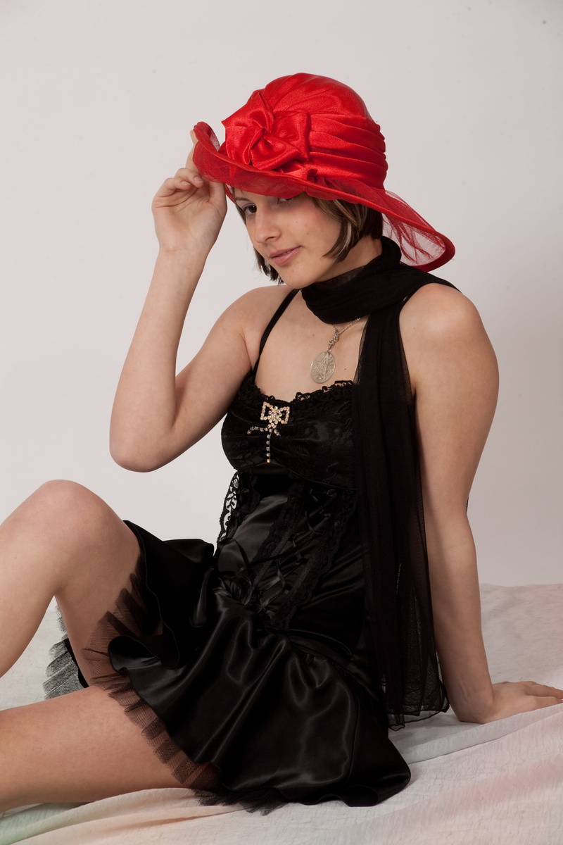 cute, one person, photo session, pretty woman, young adult, female, red, red hat, dress, sitting, black dress, lifestyles, wall - building feature, attractive