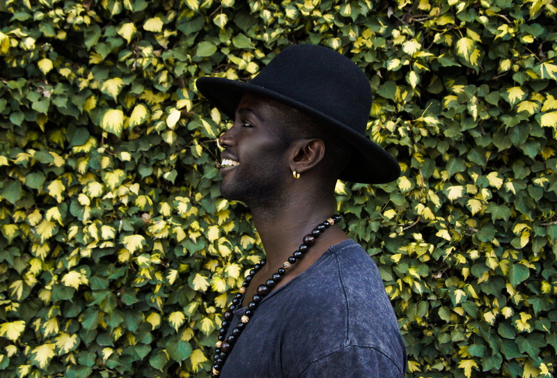 beaded, looking, male, real people, people, wearing, young adult, necklace, leisure activity, 2K, one Person, leaf, color Image, hat, outdoors, black