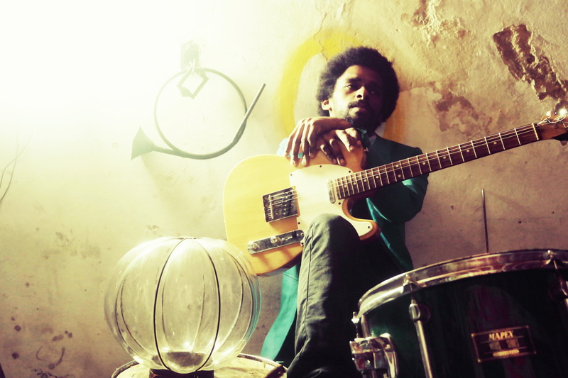 hairstyle, performance, holding, wall - building feature, three quarter length, casual clothing, musical instrument, music, essay, drum - percussion instrument