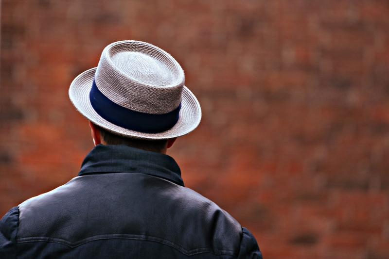 warm clothing, brick, suit, one person, well-dressed, shoulders, men, day, headgear, rear view, 2K, unrecognizable person, from behind, headshot, brick wall