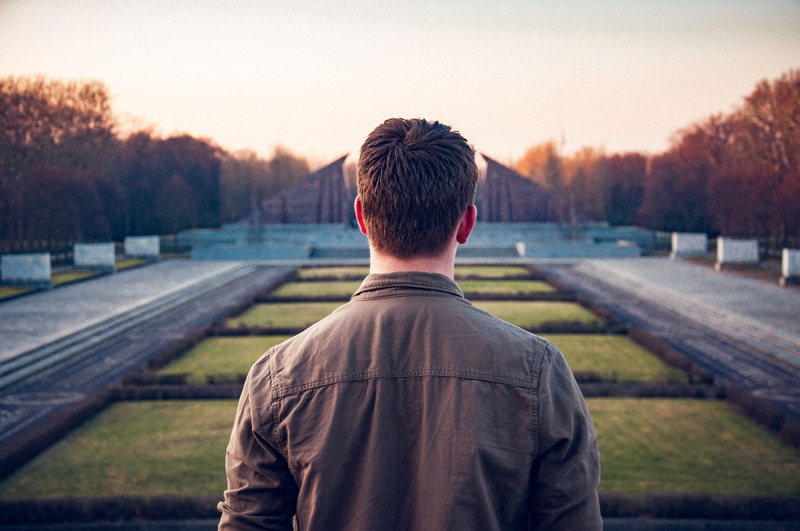 outdoors, human, lifestyles, focus on foreground, adult, person, standing, sunset, memorial, architecture, headshot, germany, daytime, berlin, sky, anonymous