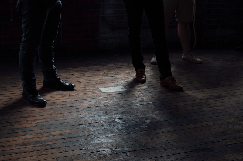 three people, human body part, night, leisure activity, flooring, parquet, adults only, wood, adult, wooden, brown, lifestyles, real people, dark, shoe