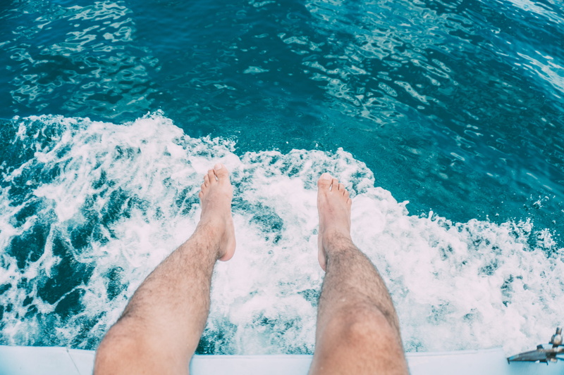 human leg, pool, leisure activity, low section, high angle view, swimming, human foot, wet, day, barefoot, lifestyles, real people, swimming pool, one person