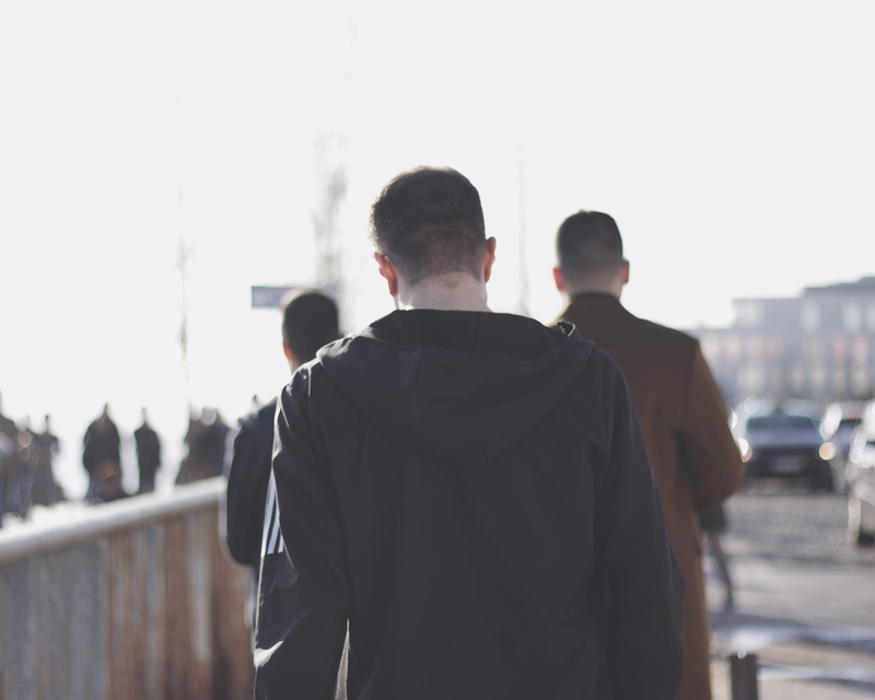 waist up, leisure activity, walking, men, day, head down, sky, people, city life, real people, nature, moving, solo, lifestyles, outdoors, architecture