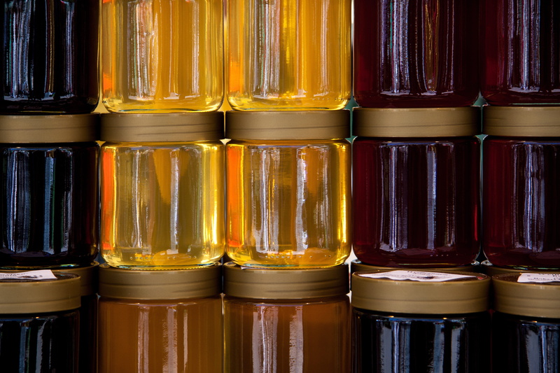 flower honey, red, shelf, stack, in a row, abundance, still life, honey yellow, retail, choice, yellow, order, side by side, arrangement, close-up, indoors