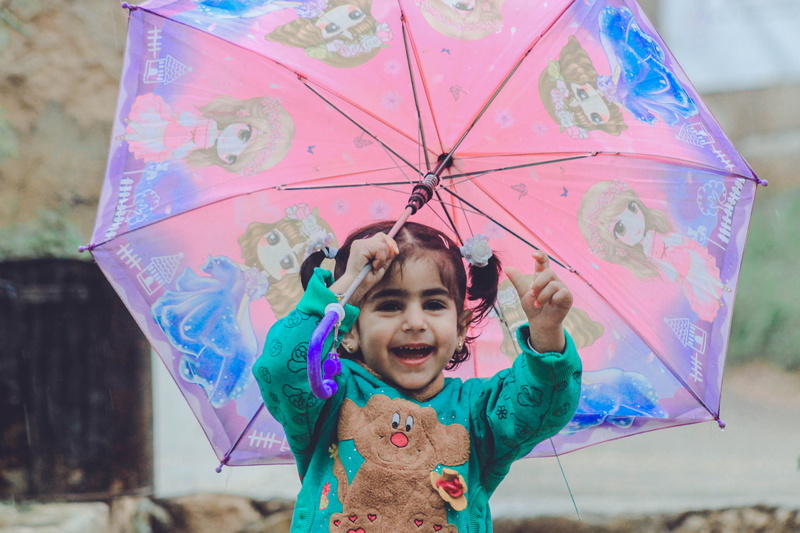 human arm, smiling, body part, emotion, fashion, leisure, front view, summer, toddler, females, holding, women, beautiful, cute, umbrella, joy, person
