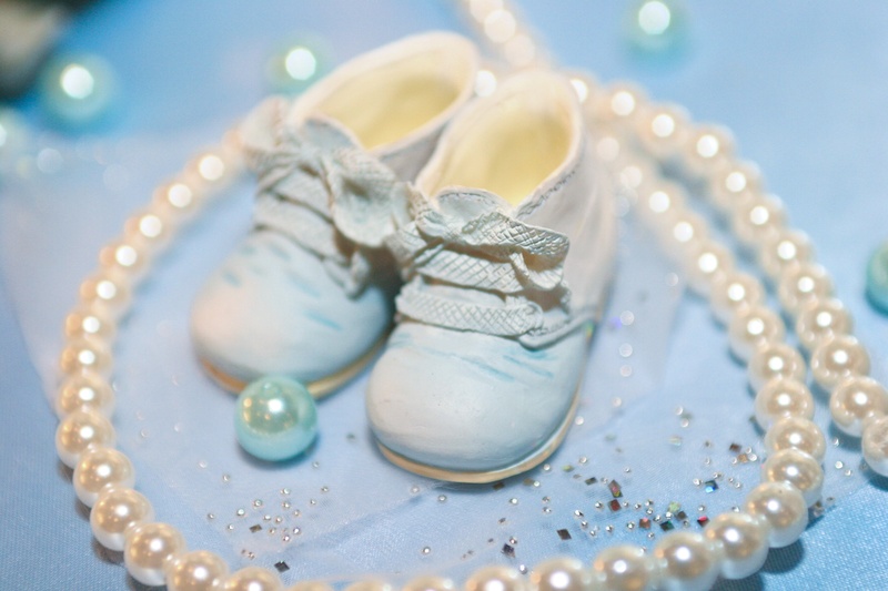 jewelry, s, 2K, personal accessory, sweet food, high angle view, close-up, still life, luxury, wealth, cake, cyan light blue, baby shoes, table, celebration