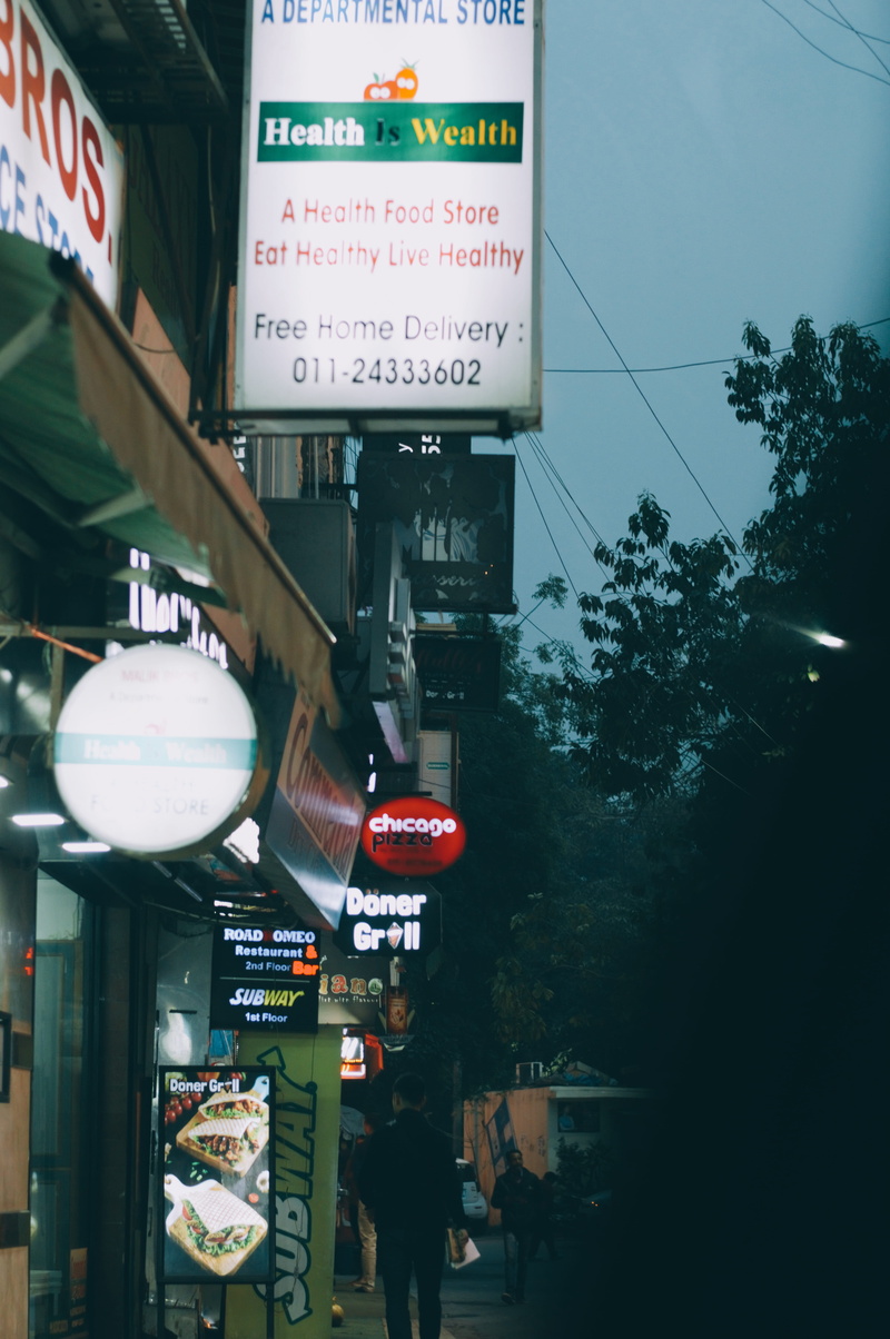 crowd, defence colony main market, road, script, information sign, business, india, communication, shops, people, built structure, buildings, new delhi