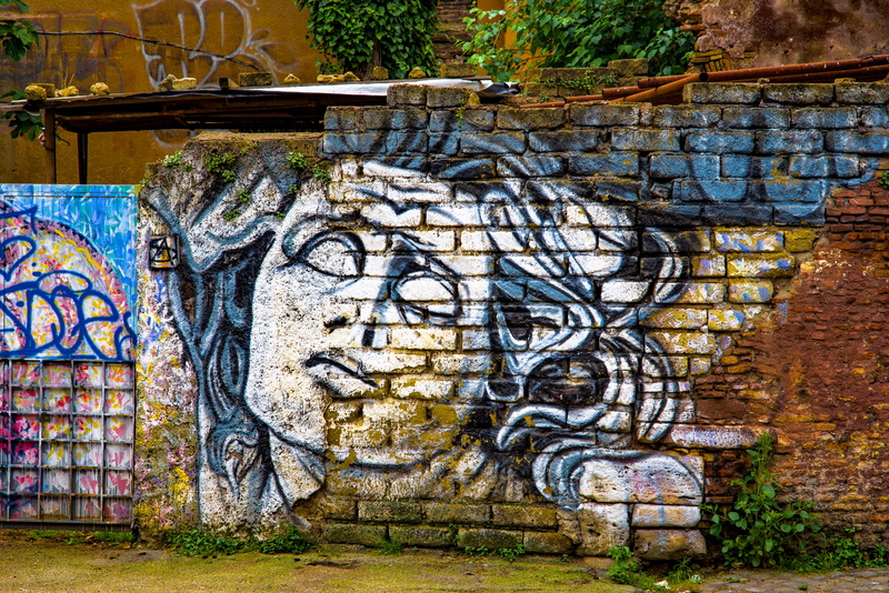 graffiti, history, brick wall, abandoned, outdoors, face, built structure, painting, no people, trastevere, old, paint, creativity, italy, craft, brick