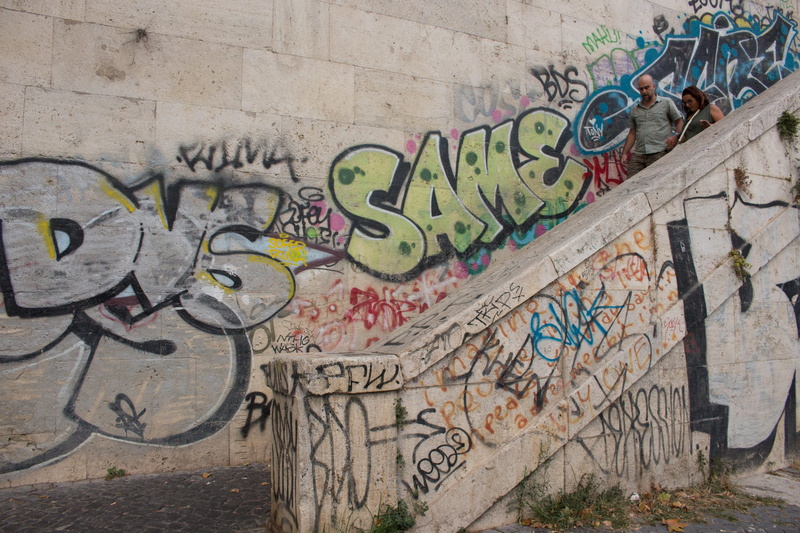 wall - building feature, person, communication, western script, clothing, city, apparel, spray paint, Rome, built structure, People, outdoors, day, Trastevere