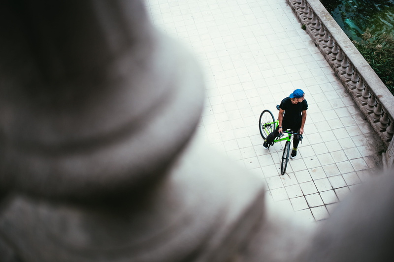 focus on background, black dress, transportation, focus, men, rear view, high angle view, city, cap, bicycle, male, blue, street, view from above, selective focus