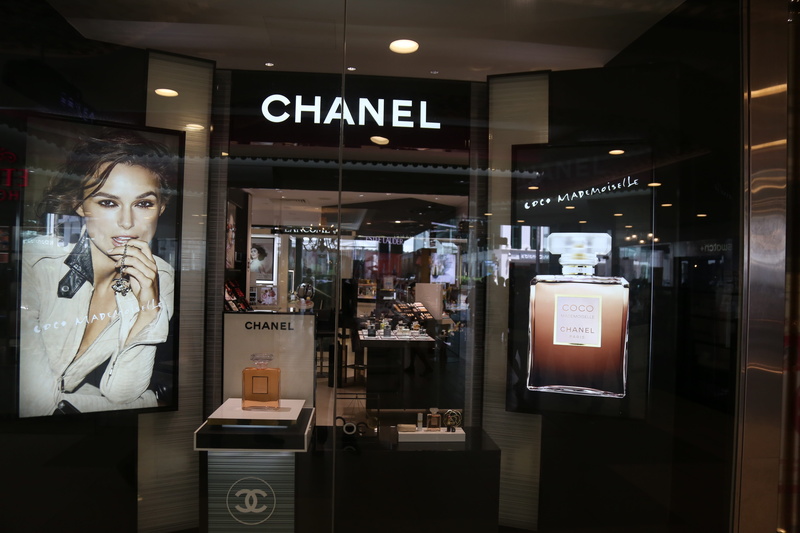 young adult, store front, indoors, illuminated, Chanel, Marketing, clear, glass, one person, wireless technology, technology, reflection, western script