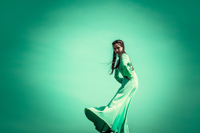 young adult, beautiful woman, clothing, greens, posture, one person, colored background, girl, young women, green, youth, women, blue background, long hair