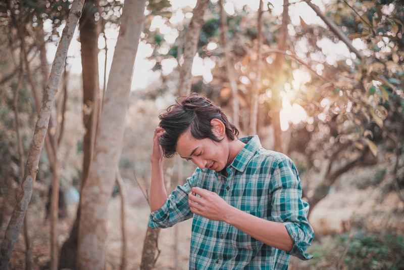 tree, man, front view, young adult, land, 5K, focus on foreground, nature, plaid shirt, standing, woodland, hairstyle, looking, leisure activity, outdoors
