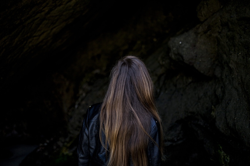 leather jacket, one person, nature, solid, long hair, adult, real people, hairstyle, rear view, rock - object, lifestyles, young adult, girl, outdoors