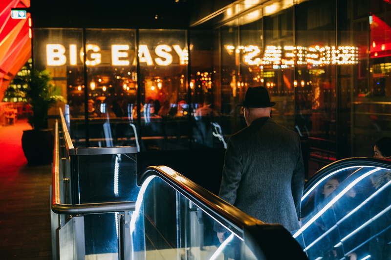 sign, rear view, escalator, men, group of people, screenshot, going, real people, chair, people, business, glass, architecture, night, man, incidental people