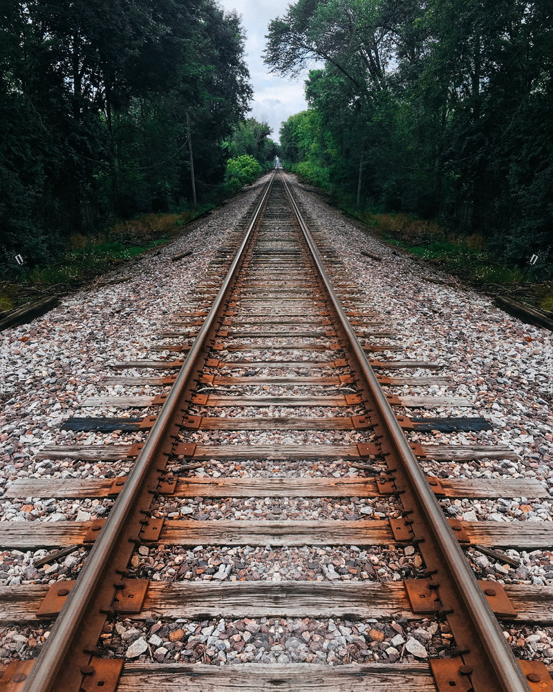 land, railroad track, trees, mode of transportation, transportation, railway, parallel, pebble, connection, stones, vanishing point, no people, metal, track