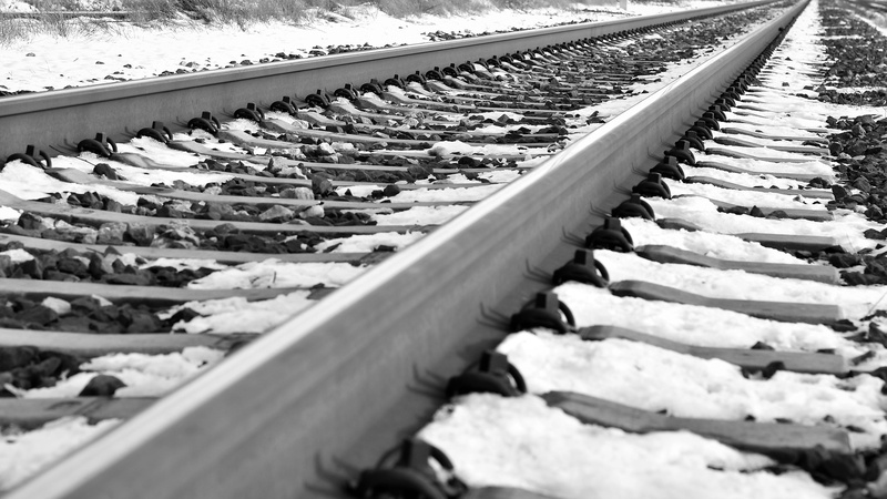 gravel, mode of transportation, railroad in winter, sunlight, horizon, icy, outdoor, railroad tie, metal, the way forward, surface level, high angle view