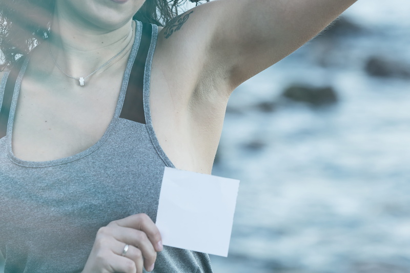 armpit, lifestyles, leisure activity, communication, paper, message, adult, hair, human body part, real people, one person, midsection, outdoors, waxing