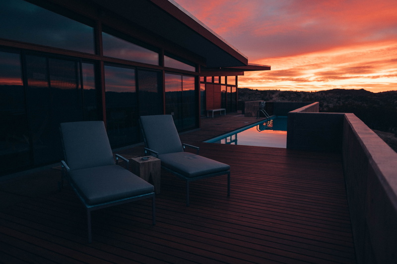 building exterior, dusk, building, chair, sunlight, table, built structure, deck, terrace, hardwood, luxury, modern, computer, wood, absence, nature, seat