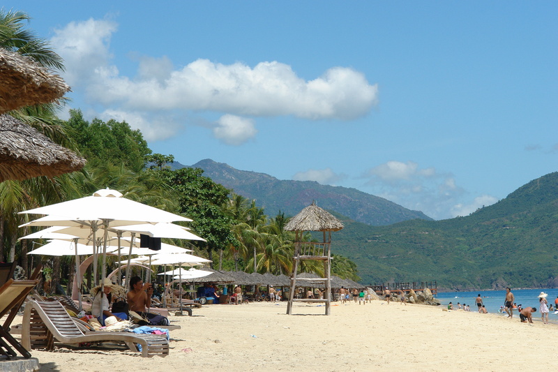 sea, khanh hoa, beach, trip, vacations, leisure activity, sand, beauty in nature, mountain, water, tree, day, crowd, outdoors, group of people, nature
