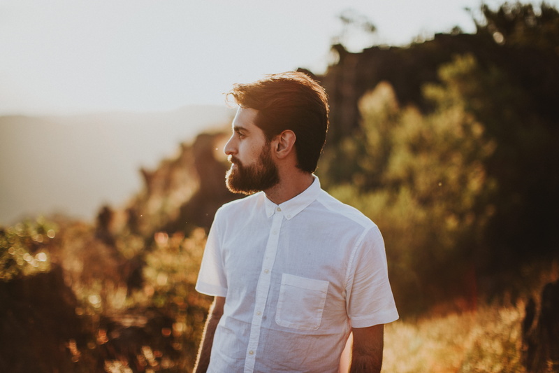looking away, outdoors, dating, standing, sleeve, sports, sky, trees, nature, facial hair, white, shirt, surround, casual clothing, t-shirt, people, waist up