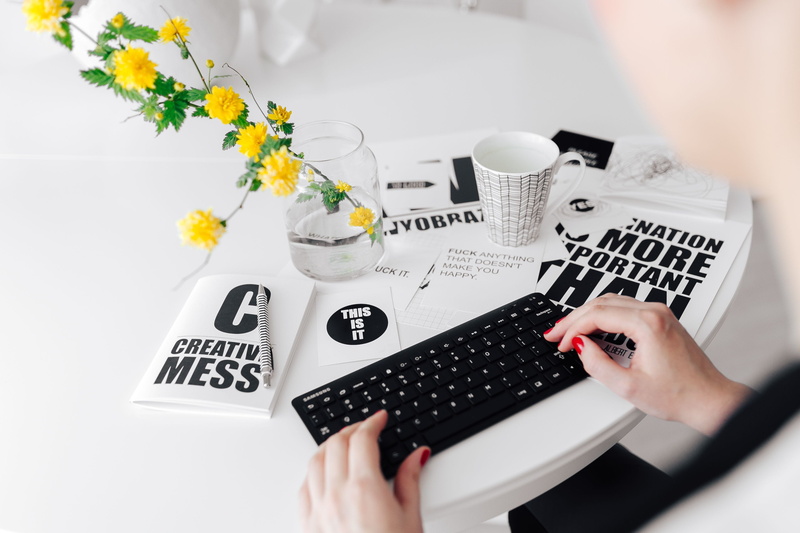 human hand, indoors, plant, table, writing, desk, coffee cup, bouquet, remote, scandinavian, keyboard, flowering plant, workplace, flower, typing, coffee - drink