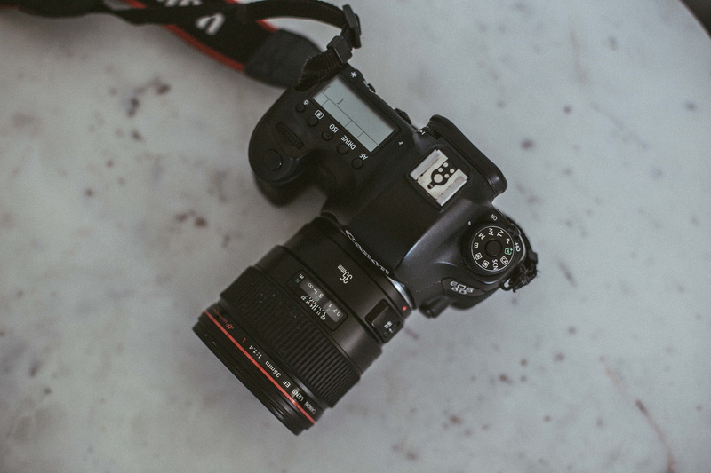 text, tape player, bracket, photographic equipment, photography themes, dslr, stitch, camera lens, slr camera, focus on foreground, technology, canon, id cards